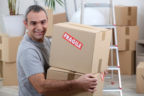 Removal team preparing a move in Putney with packed boxes and furniture