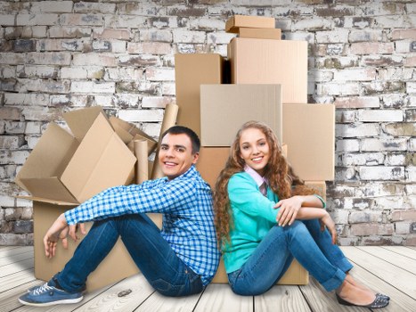 Packed apartment move with boxes and protective wrapping in Putney