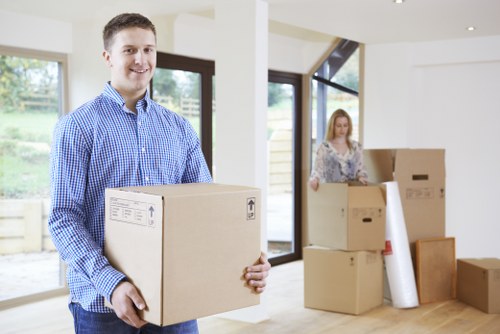 Moving van and packed boxes outside a Putney home