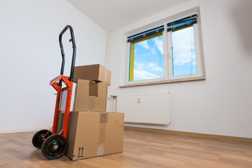 Furniture and boxes being unloaded at a new Putney home