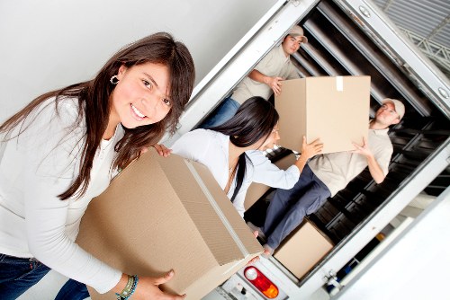 Removal workers assessing risks before carrying furniture in Putney